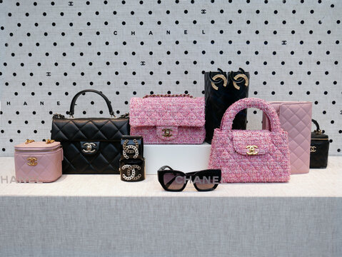 Chanel haute couture accessories : iconic Timeless handbag, chanel style in black leather and pink tweed.  Sunglasses 
