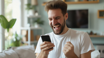 Man celebrating while looking at his smartphone