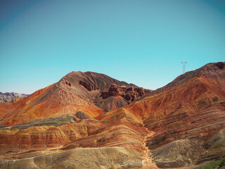 Colourful mountain with utility pole on top