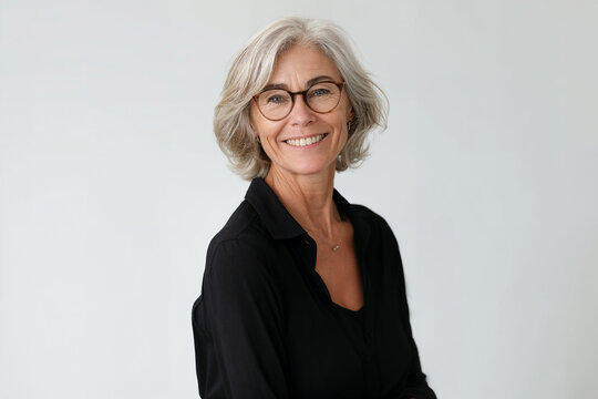 Smiling mature female architect wearing glasses captured in a realistic style against a white background. Woman CEO. Business person. Corporate business portrait. 