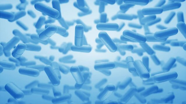 Capsules are moving upward on a blue background. Tablet pills capsules float slowly in slow motion. 3d Loop Animation, 4K