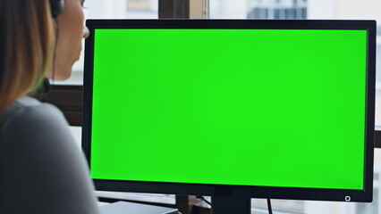 Call operator using chromakey computer closeup. Corporate manager looking green - obrazy, fototapety, plakaty