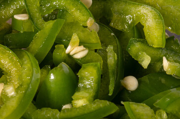 Raw sliced green jalapeno pepper, top view, close up. 