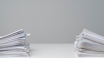 Time lapse of paper sheets on white background. Stop motion animation of similar two stacks with...