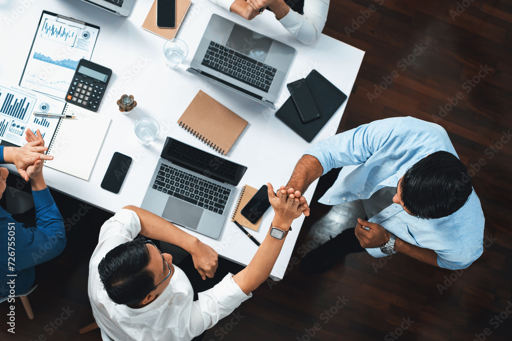 Poster top view diverse office employee worker high five after making agreement on strategic business marke
