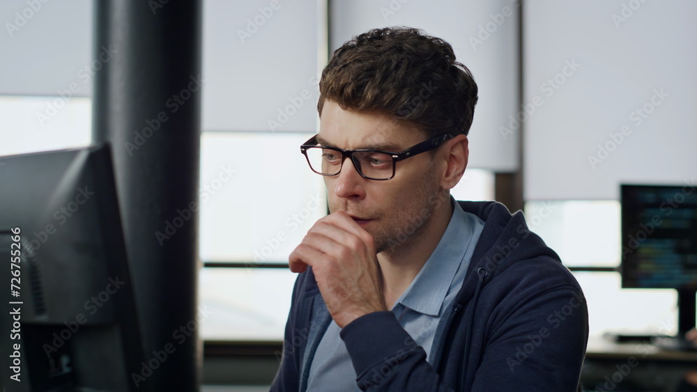 Poster focused manager look screen at workplace closeup. serious programmer analyzing