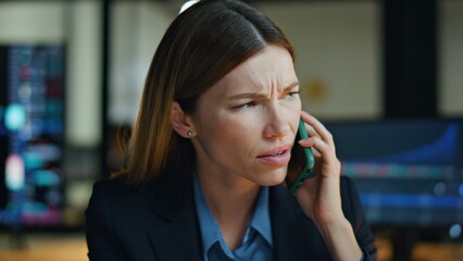 Serious woman talk mobile phone in office closeup. Nervous businesswoman discuss