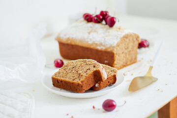 Homemade nut cake with cherrys on white background. Aesthetic breakfast concept.