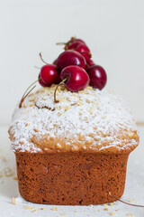 Homemade nut cake with cherrys on white background. Aesthetic breakfast concept.