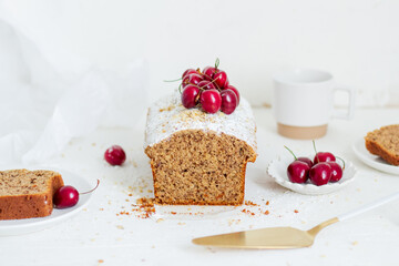 Homemade nut cake with cherrys on white background. Aesthetic breakfast concept.