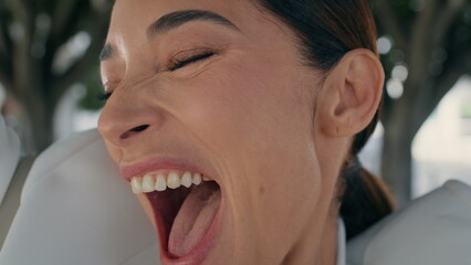 Closeup emotional woman laughing rejoicing success outdoors. Girl feeling joy