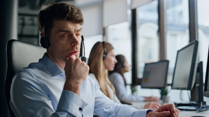Thoughtful agent talking headset with client closeup. Professional support agent - obrazy, fototapety, plakaty