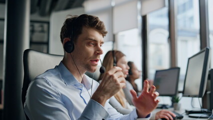 Operator listening customer online in office. Focused man agent think solution