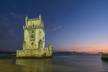 Illuminated Torre de Belem during evening twilight after sunset with planets Venus and Saturn on...