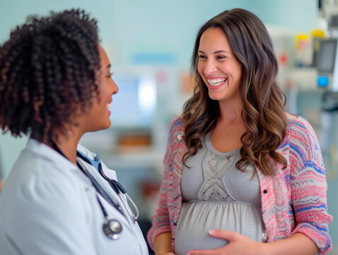 An African American female gynecologist consults a pregnant young Hispanic female patient in her office