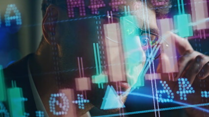 Focused businessman analysing sales in futuristic investment hologram closeup.