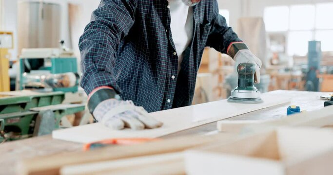 Engineering, carpentry and closeup of man with grinder in a workshop manufacturing furniture. Woodwork, industry and zoom of male industrial worker working and building timber with tools in warehouse