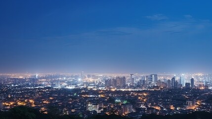 A View of a City at Night From the Top of a Hill