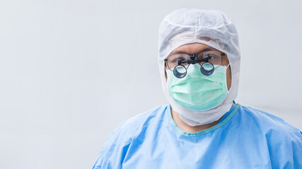 Headshot of male brain or orthopedic surgeon isolated on white background inside operating room...