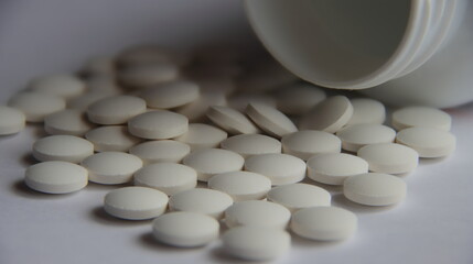 white pills on white background