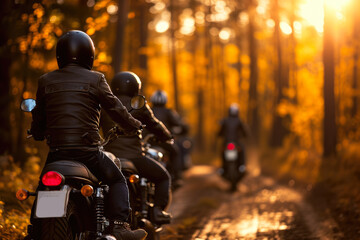 group of motorcyclists riding through a forest at sunset. The riders are wearing helmets and...
