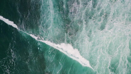 Top stormy sea surface waving with white foam slow motion. Aerial ocean waves 