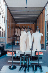 Unloading male mannequins from a truck for publication, design, poster, calendar, post, screensaver, wallpaper, cover, website. High quality photo