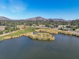 Aerial view over water reservoir and a large dam that holds water. Rancho Santa Fe in San Diego, California, USA