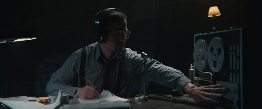 An intelligence officer works at the wiretap station