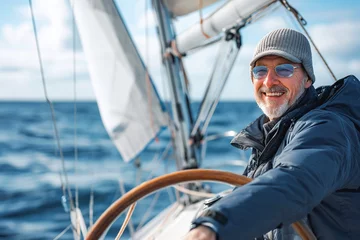 Fotobehang Smiling mature man sailing his yacht on a sunny day © VisualProduction