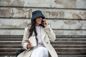 young woman calling cellular with take away chinese food