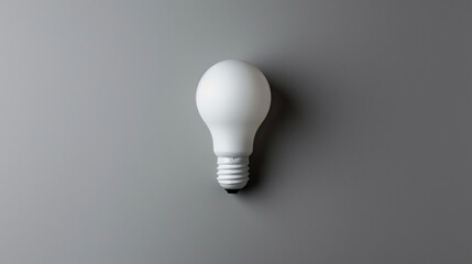 White Light Bulb Illuminating a Gray Wall