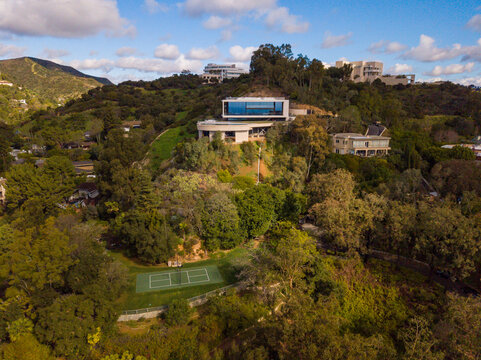 Panoramic views of the affluent Brentwood neighborhood, with mansions in the foothills of the santa monica mountains, with the Getty Museum in the background.