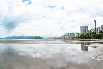 Buildings and City Skyline Reflecting in Wet Sandy Beach in Santos Brazil