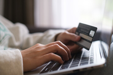 Hands holding credit debit card and using keyboard on laptop at home. Online shopping ,network banking account payment money for buy or purchase and sale concept.
