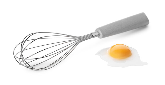 Whisk and raw egg isolated on white