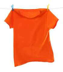 One orange t-shirt drying on washing line isolated on white