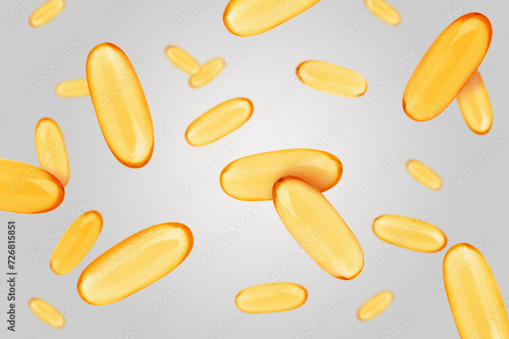 Sticker Vitamin. Softgel capsules falling on light grey background