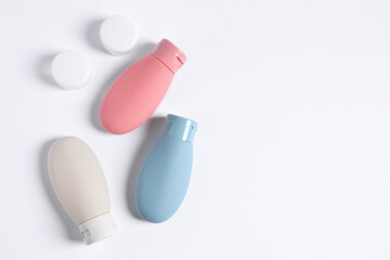 Cosmetic travel kit on white background, flat lay. Space for text