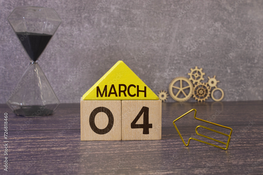 Poster march 4 calendar date text on wooden blocks with blurred park background. copy space and calendar co