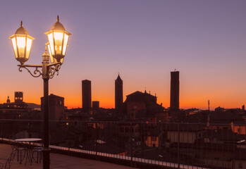 Old medieval towers at sunset in Bologna.