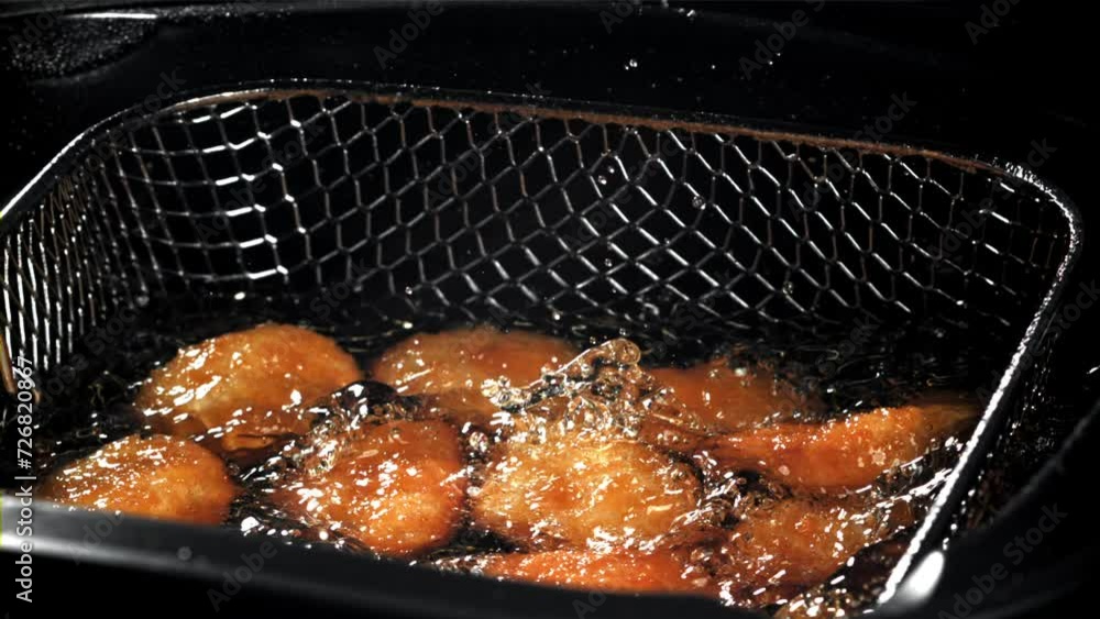 Sticker Chicken nuggets fall into hot oil. Filmed on a high-speed camera at 1000 fps. High quality FullHD footage