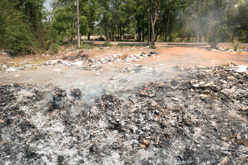 Garbage, fire burning and smoke in landfill. Also called trash, waste, rubbish. Destruction with combustion, heat, flame. Effect to environmental i.e. air pollution, toxic, disaster and global warming