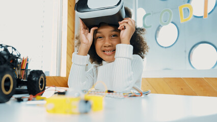 African girl taking off VR glass or head set while looking at camera. Student smiling at camera...