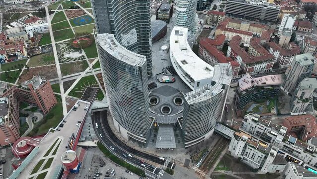 The high tower of the unicredit bank. Square with fountains in 4k