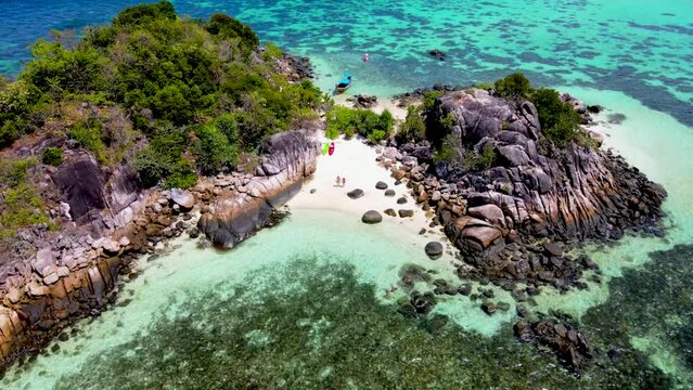 a couple of men and women at Kla Island Koh Lipe Thailand a small island on the coast of Ko Lipe with a coral reef and great snorkeling place