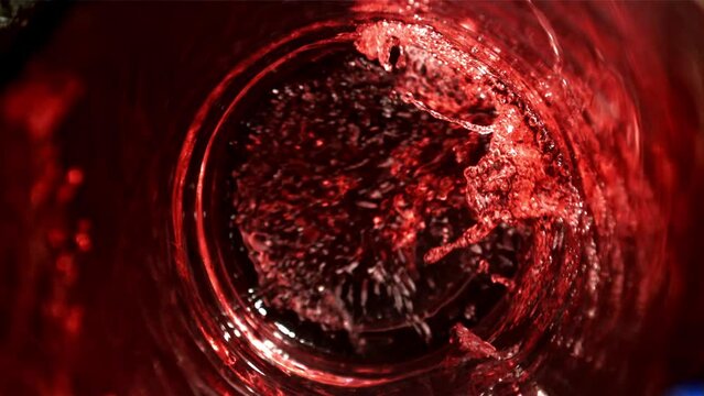 Red wine is poured into a glass. Top view. Filmed on a high-speed camera at 1000 fps. High quality FullHD footage
