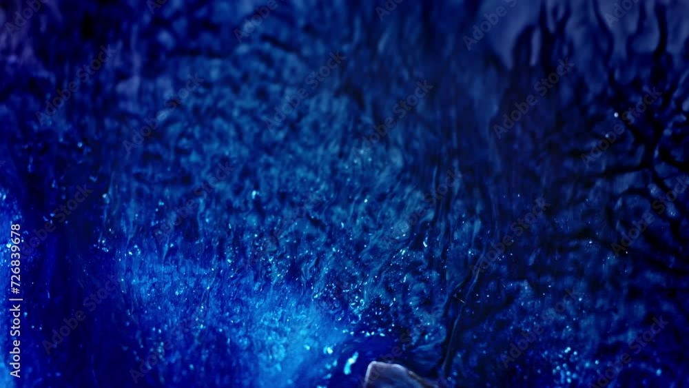 Poster abstract blue ink spreading in water creating an ethereal mixture of patterns