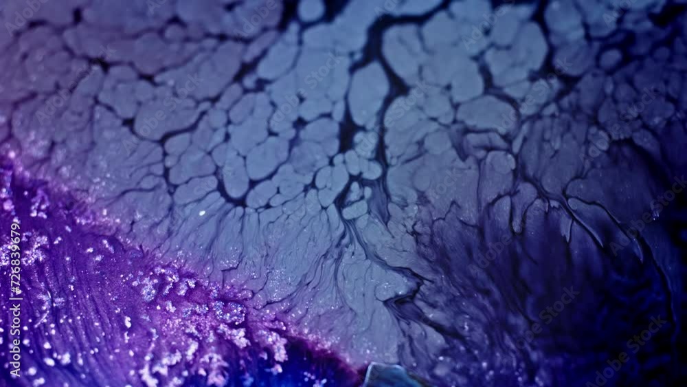 Poster close-up of purple ink dispersing in water, creating an abstract pattern