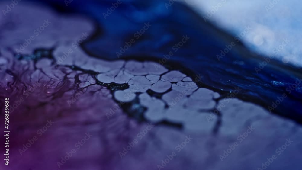 Poster blue ink spreading in water creating abstract patterns, resembling aerial view of a river